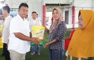 Wakil Bupati Deddy Abdul Hamid secara simbolis memberikan bahan makanan di acara Gerakan Pangan Murah, di Molibagu, Sabtu 30 Agustus 2025. (Foto: IST)