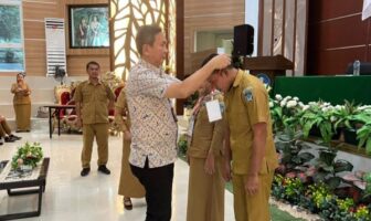 Salah satu peserta bimtek saat disematkan kartu pengenal sebagai tanda peserta bimtek yang berlangsung di gedung Balai PEnjamin Mutu Pendidikan, Manado, Selasa 2 Desember 2025. (Foto: IST)